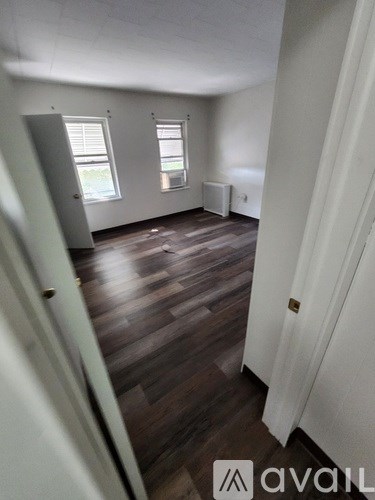 A room with wooden floors and white walls.