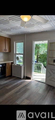 A kitchen with wooden cabinets and a white ceiling.