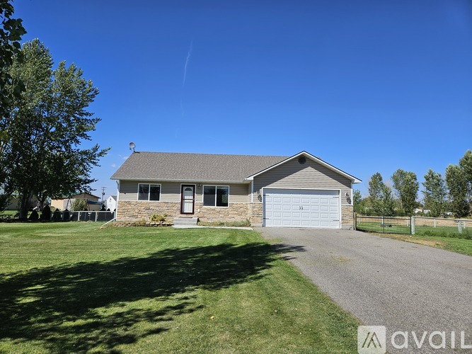A house with a garage is for sale.