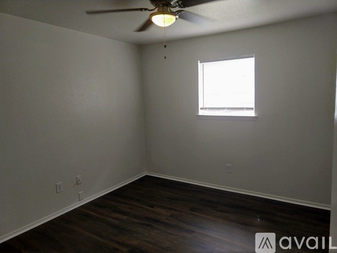A room with a ceiling fan and a window.
