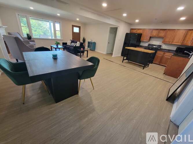 A modern kitchen with dark wood cabinets and a black island.