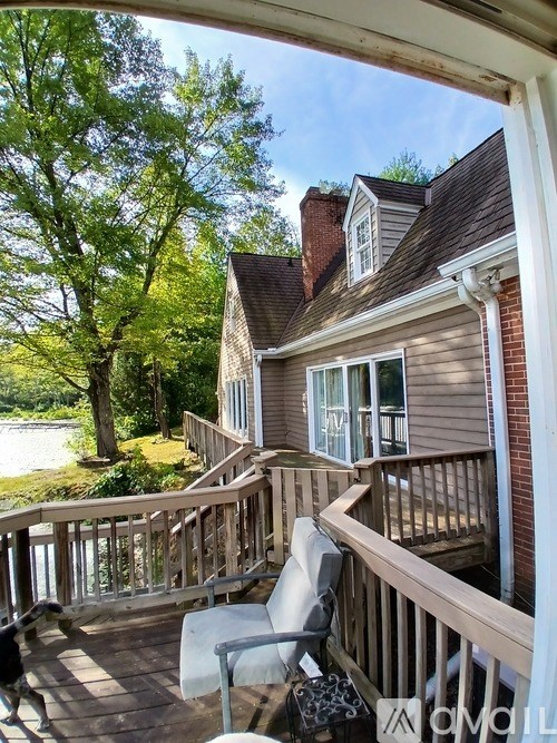 A house with a deck and a chair.