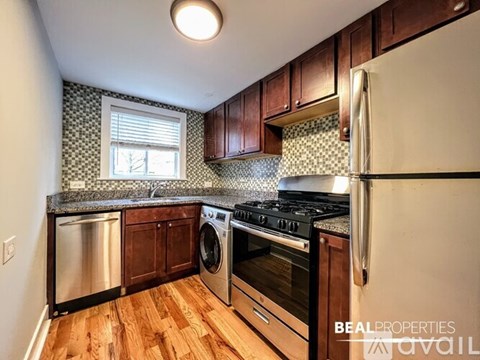 A kitchen with wooden cabinets and a black stove top oven.