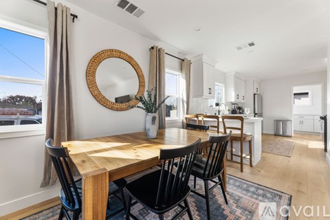 A modern dining room with a wooden table and chairs.