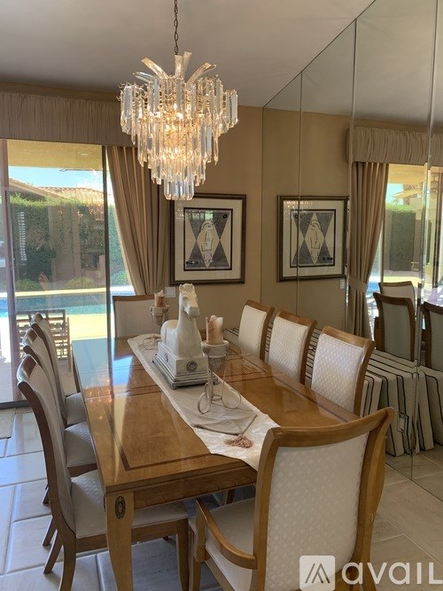 A dining room with a wooden table and chairs.