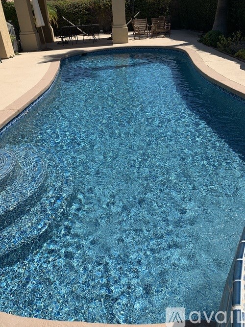 A swimming pool with a blue tinted water.