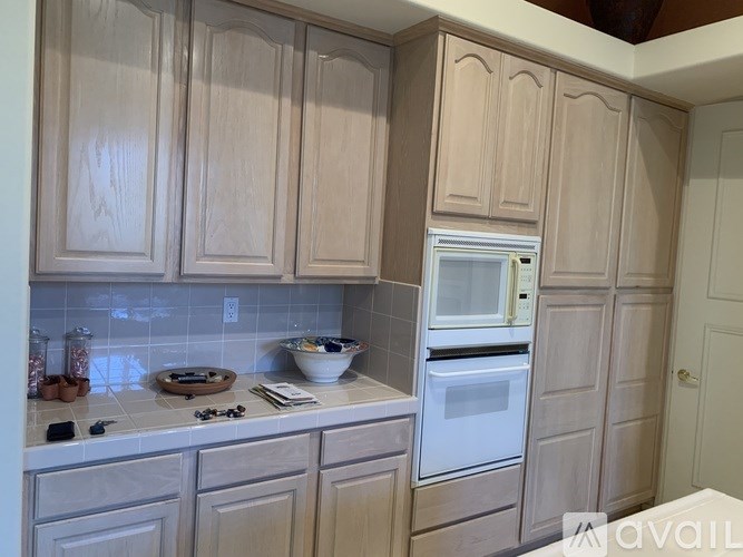 A kitchen with wooden cabinets and a white oven.