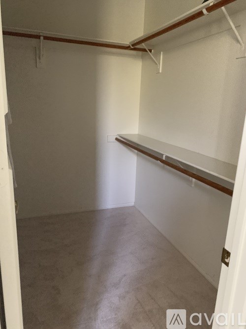 A white room with a shelving unit and a door.