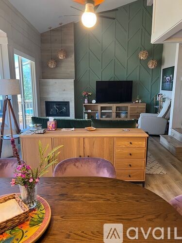 A living room with a wooden table and a television.