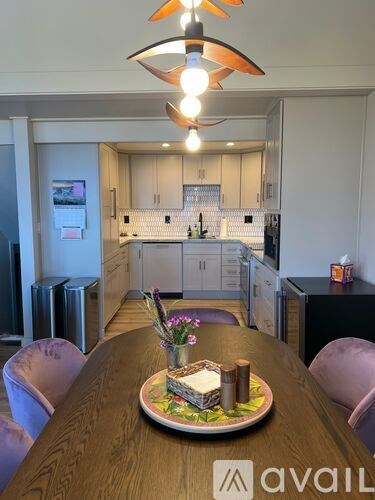 A kitchen with a table set for four.