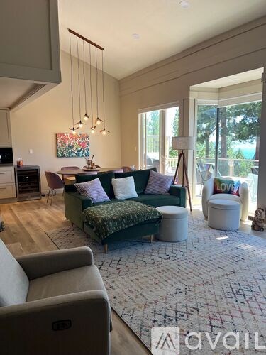 A living room with a couch, a chair, a sofa, and a rug.