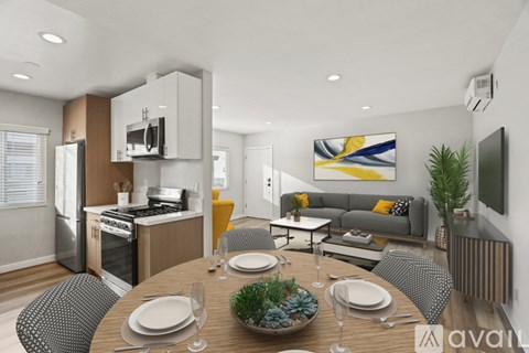 A modern kitchen with a dining table set for two.