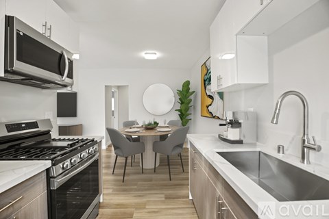 A modern kitchen with a dining table and chairs.