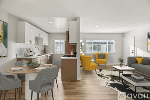 A modern kitchen and living room with a dining table set for four.