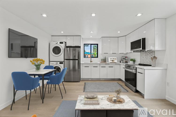 A modern kitchen with a dining table and chairs.