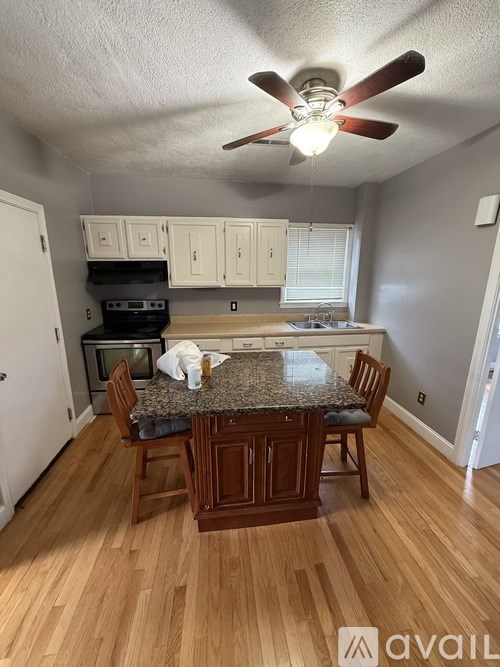 A kitchen with a table and chairs in the middle of the room.