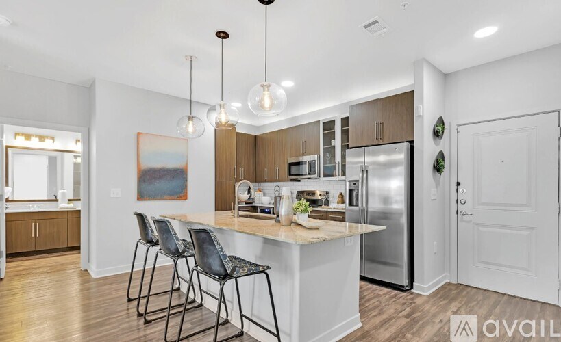 A kitchen with a bar area and a painting on the wall.