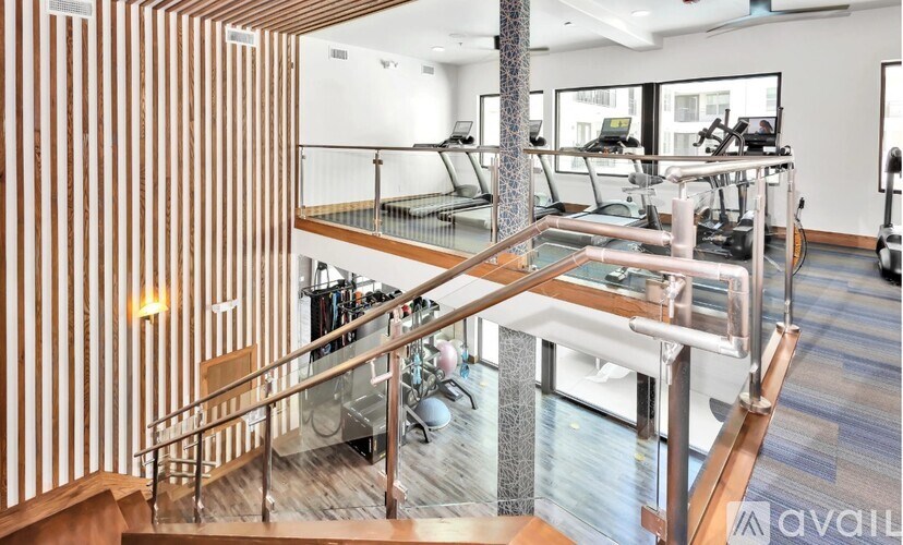 A gym with a variety of equipment including treadmills, stationary bikes, and weight machines.
