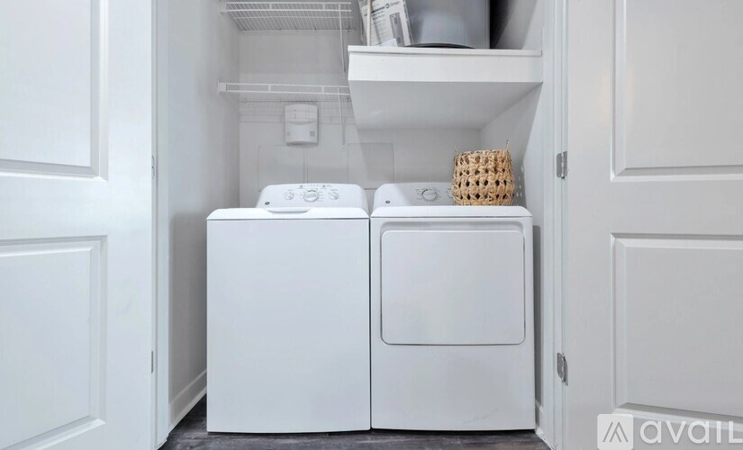 A white washing machine and dryer in a small laundry room.