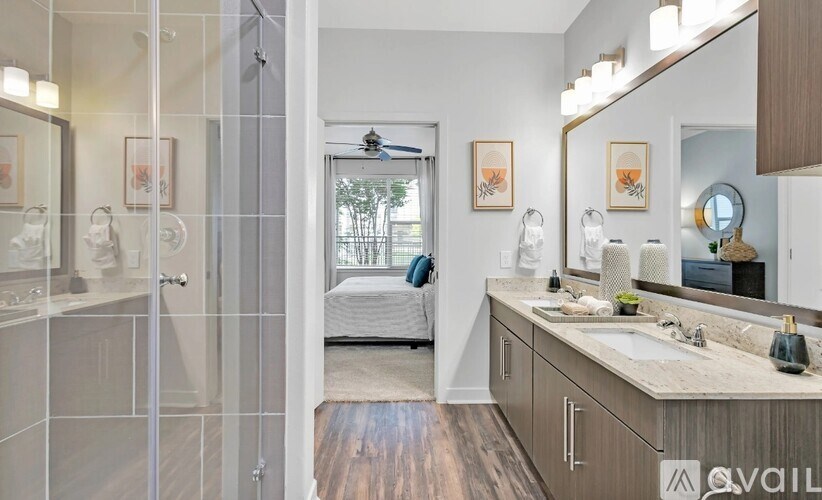 A bathroom with a walk-in shower and double sink vanity.