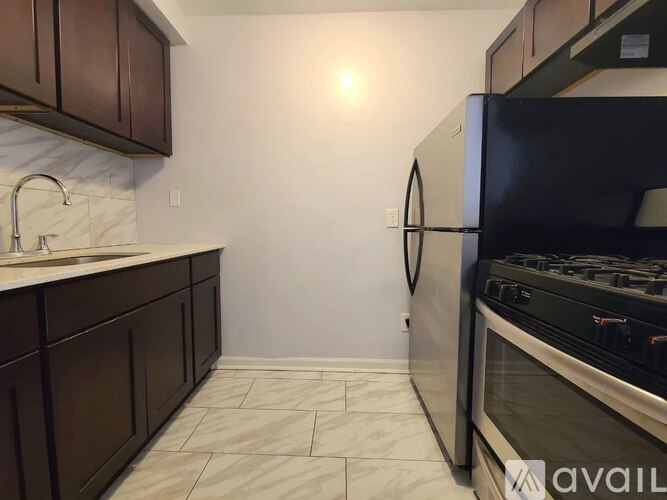 A kitchen with a black fridge and a black stove.