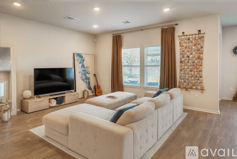 A living room with a large couch and a television.