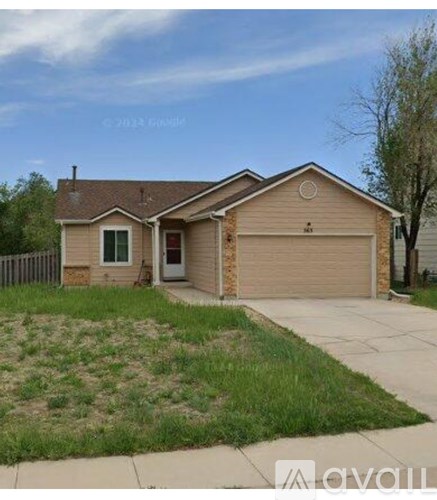 A house with a garage and a driveway in front.