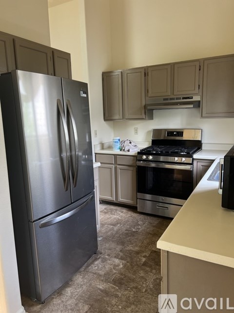 A kitchen with a black fridge and stove.