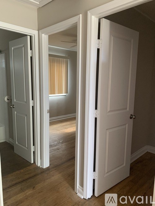 A hallway with two doors on either side leading to other rooms.