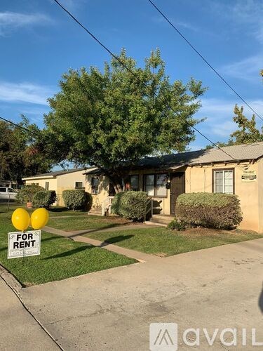 A house with a "For Rent" sign in front of it.