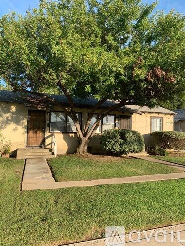 A tree in front of a house.
