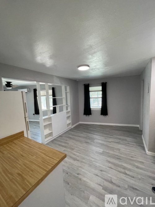 A room with a wooden floor and a white ceiling.