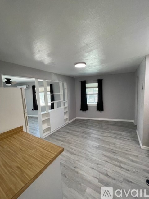A room with a wooden floor and a white ceiling.