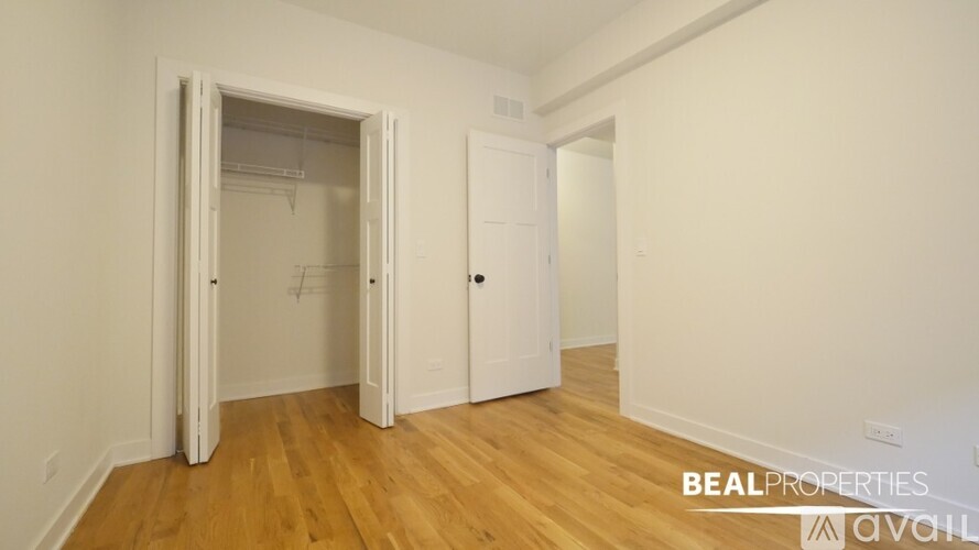 A room with a white door and a white wall with a BEALPROPERTIES AVAILABLE sign.