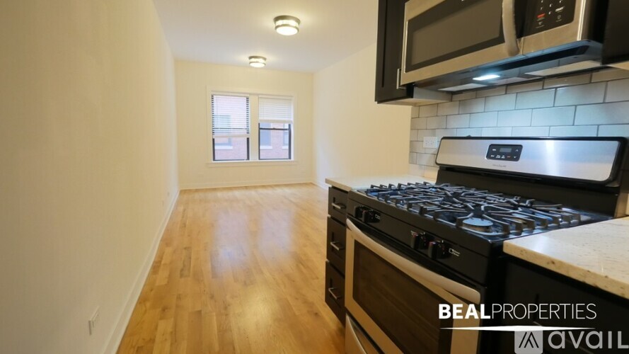 A kitchen with a stove top oven and microwave above it.