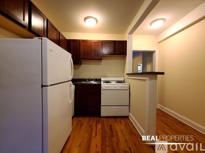 A kitchen with a white refrigerator and a white stove top oven.