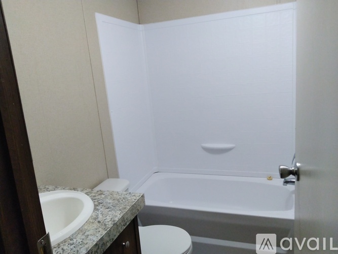 A bathroom with a white bathtub, sink, and toilet.
