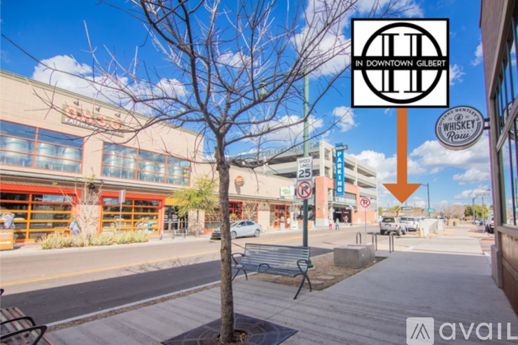 A street view with a sign for "Whiskey Row" and a logo for "In Downtown Gilbert.".