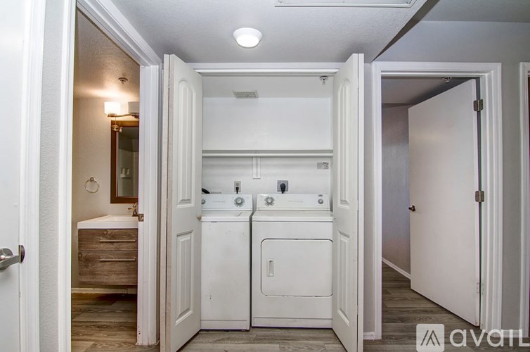 A bathroom with a toilet, sink, and mirror.