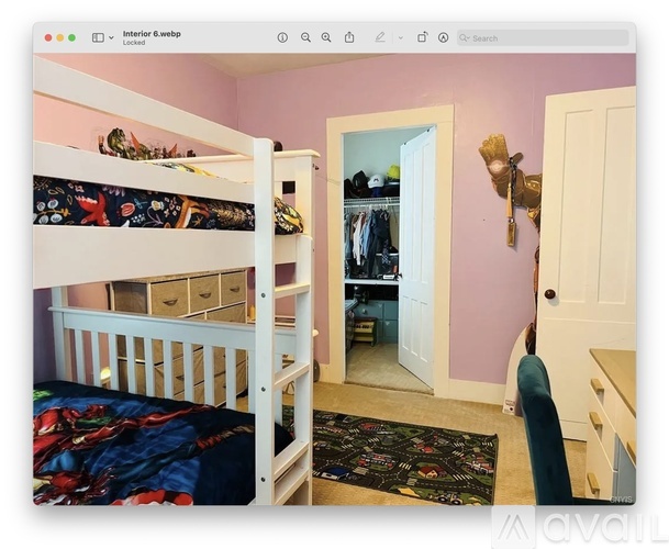 A bedroom with a bunk bed and a wardrobe.