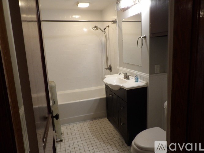 A bathroom with a toilet, sink, and bathtub.