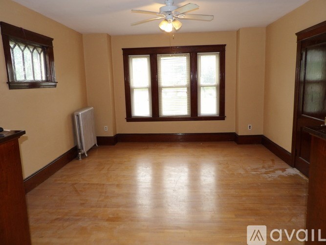 A room with wooden floors and a ceiling fan.