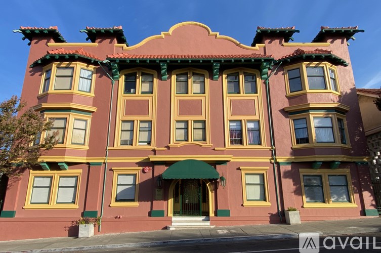 A red building with yellow trim and green awnings.