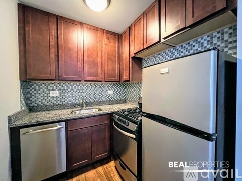 A kitchen with wooden cabinets and a white refrigerator.