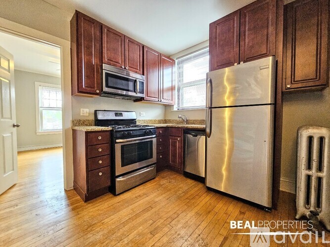 A kitchen with wooden cabinets and stainless steel appliances.