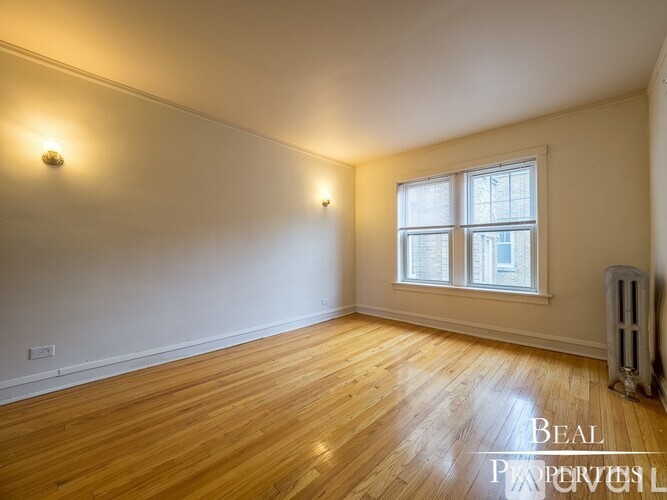 A room with wooden floors and a window.
