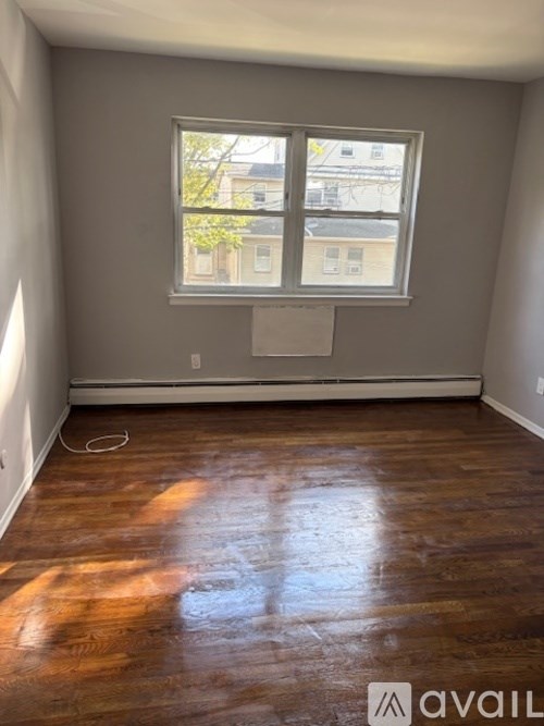 A room with wooden floors and a window.