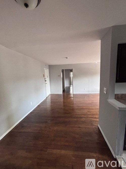 A room with wooden floors and white walls.