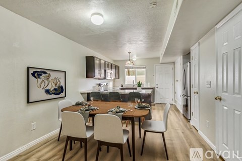 A dining room with a wooden table and chairs.