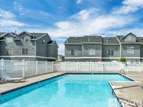 A swimming pool in front of apartment buildings.